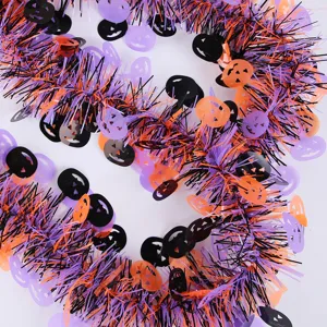 Halloween tinsel garland with pumpkin cutouts, black orange and purple spooky party decor.
