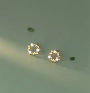 Detailed shot of S925 silver wreath ear studs, featuring minimalist forest style and sparkling stones.