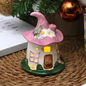 Ceramic fairy house night light with pink hat design, cozy ambient lamp for desk decor.