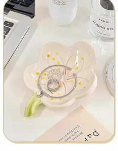 Ceramic flower jewelry tray detail view, elegant desktop storage dish for rings and bracelets.