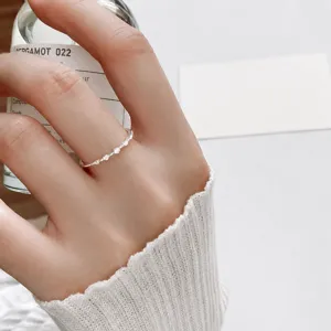 Delicate minimalist 925 silver micro-set diamond dainty ring detail closeup view.