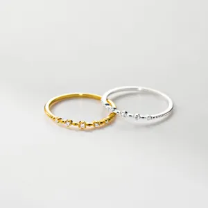 Close-up of delicate micro-pave sterling silver stacking rings with sparkling tiny stones.