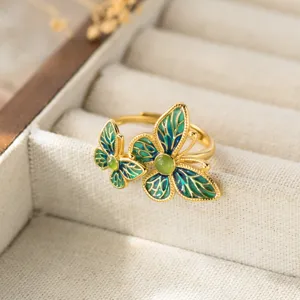 Detail view of Chinese retro style S925 silver green jade enamel double butterfly ring.