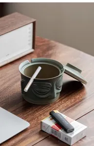 Ceramic creative ashtray with lid retro Sanxingdui bronze mask home desktop decoration.