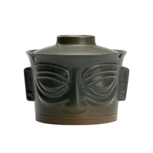 Retro ceramic ashtray with lid, creative Sanxingdui mask design, vintage dark green tabletop decor.