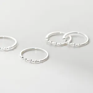 Detailed view of S925 sterling silver stackable rings with delicate micro-set cubic zirconia.
