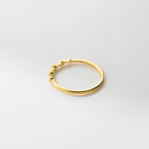 Delicate gold-plated 925 sterling silver thin ring with tiny sparkling stones and classic beads.