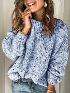 Close-up detail of women's casual blue speckled knit sweater, long sleeve and fabric.