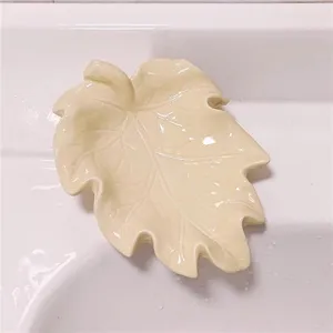 Leaf-shaped soap dish detail view, ceramic soap holder with drainage design for bathroom.