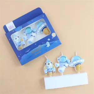 Detail shot of creative space astronaut rocket UFO birthday cake decorative candles set box.
