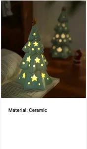 Ceramic Christmas tree night light detail, warm glow through star cutouts, cozy decor.