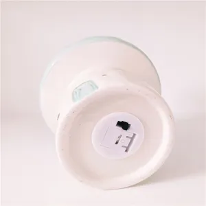 Ceramic mushroom night light detail bottom view showing battery compartment and switch.