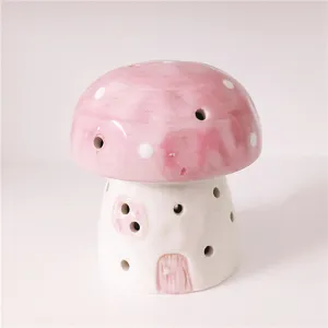 Detailed view of ceramic mushroom night light with pink dotted cap and hollow design.