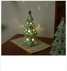 Ceramic Christmas tree night light with star cutouts, cozy bedroom tabletop decor piece.