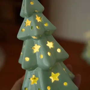 Ceramic Christmas tree night light with glowing star cutouts for bedroom decor and festive gifts.