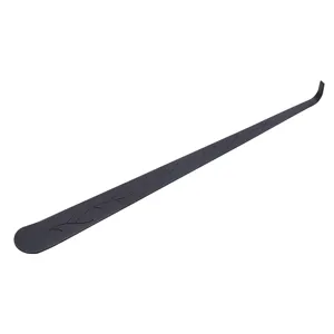 Black metal aromatherapy candle wick dipper detail, elegant leaf pattern, smooth handle.