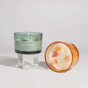Nordic colored glass scented candle detail displaying transparent jars with crystal stones inside.