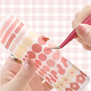 Precision pink tweezers and colorful dot flower sticker roll set for DIY craft journaling.
