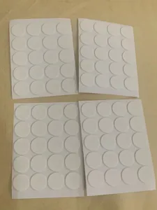 Detailed view of white circular double-sided foam glue dots, perfect for candle wick fixing and crafts.