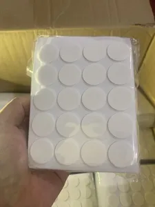 Detailed close-up view of transparent double-sided adhesive glue dots for candle wicks.