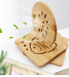 Detailed shot of bamboo insulated pot holders with carved patterns, ideal for kitchen table use.