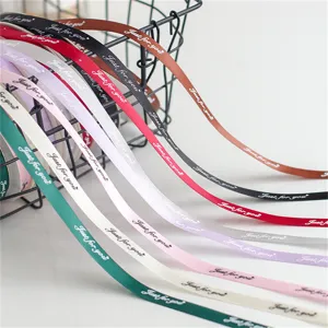 Closeup detail of colorful satin ribbon rolls with Just for you text for floral gift wrap.