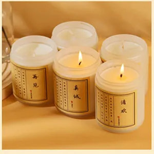 Detailed view of frosted glass scented soy candles with vintage labels, creating a warm and cozy vibe.