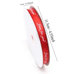 Red ribbon roll with English letters for gift wrapping, flower bouquet and DIY crafts.