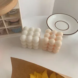 Aesthetic handmade bubble cube scented candles in white and pink for home decor and photography props.