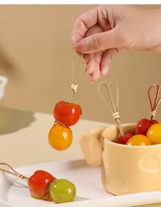 Disposable bamboo fruit skewers with heart shape loop top for party snacks and desserts.