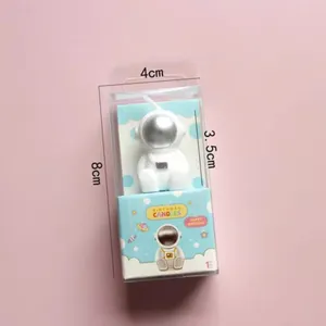 Detailed close-up of cute astronaut birthday candle in clear box, perfect for space cake decor.
