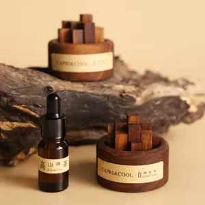 Black walnut wood aroma diffuser set with essential oil bottle for home desktop decor.