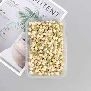 Natural dried jasmine flower buds in clear box for DIY scented candles and craft decor.