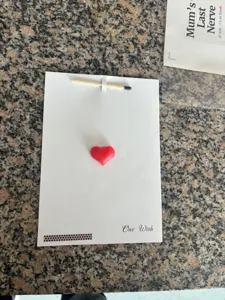 Creative greeting card with 3D red heart and matchstick design for romantic confession.