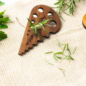 Wooden herb stripper detail showing multi-hole design and fresh rosemary on fabric.
