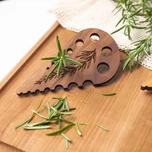 Wooden herb stripper tool with multiple holes for easily removing rosemary and thyme leaves.