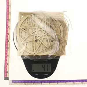 Wooden hollow dream catcher detail showing craftsmanship and weight measurement on scale.