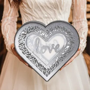 Heart-shaped wooden wedding card box with hollow leaf design and glitter love decor.