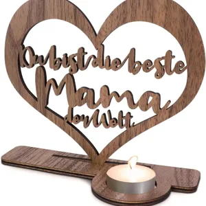 Close up of the wooden heart candle holder detail featuring hollow carved text and warm tealight.