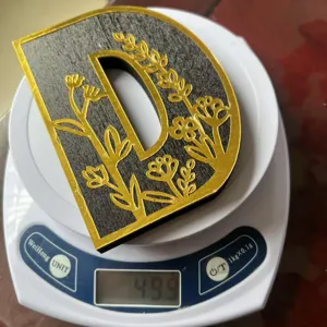 Wooden decorative carved letter D ornament detail view, showing exquisite floral pattern.