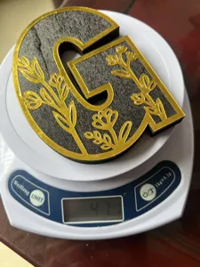 Wooden decorative letter desktop ornament with gold floral pattern, stylish piece.