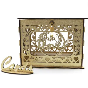 Detailed view of gold glitter wooden wedding card box with hollow heart design and lock.