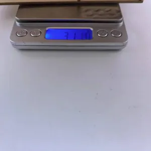 Detail view showing the weight measurement of the wooden storage box on a digital scale.