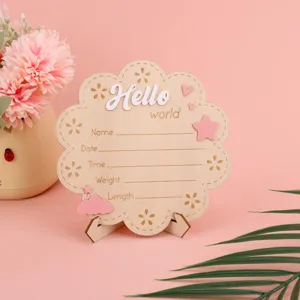 Wooden newborn milestone card detail view, baby growth photo prop background display.