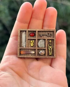 Miniature wooden trinket shelf detail, micro shadow box display with tiny items.