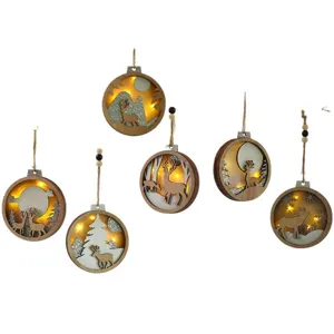 Christmas wooden hanging ornaments with lights, luminous deer and tree decor for holiday party.