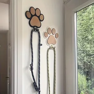 Wooden paw print wall hook detail view, stylish home decor accessory for hanging leashes and towels.