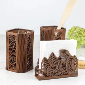 Wooden hollow leaf pattern napkin holder and cutlery storage tube set for home kitchen desktop.