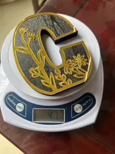 Wooden carved letter C desktop ornament detail with luxury floral design and weight display.
