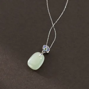 Detailed view of the S925 sterling silver oval green jade pendant necklace with cloud motif.